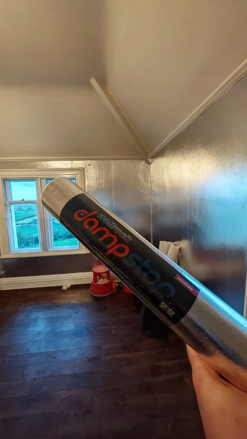 A roll of Wallrock Damp Stop thermal foil, with the walls behind already foiled