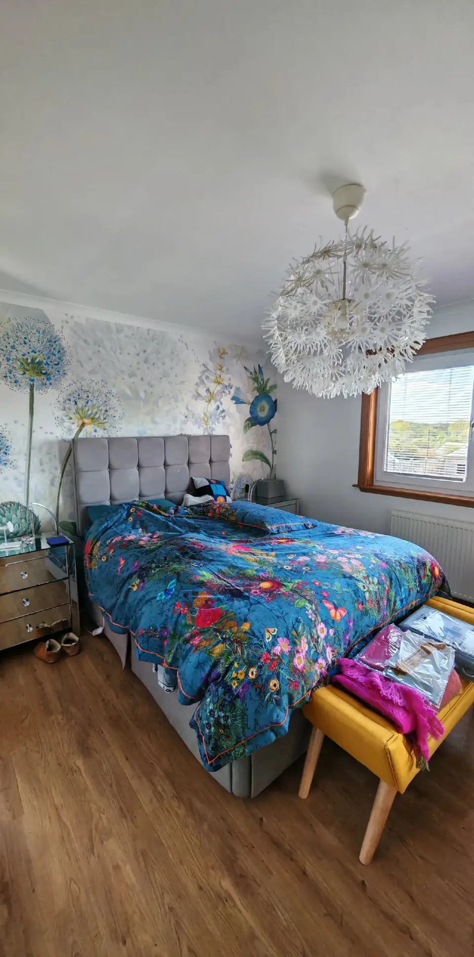 Bedroom feature wall with an allium mural behind the bed
