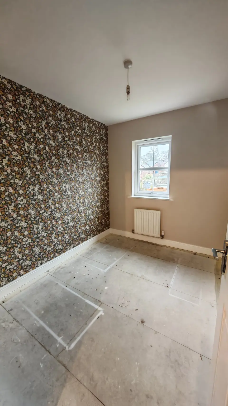 Bedroom feature wall in a ditsy floral wallpaper