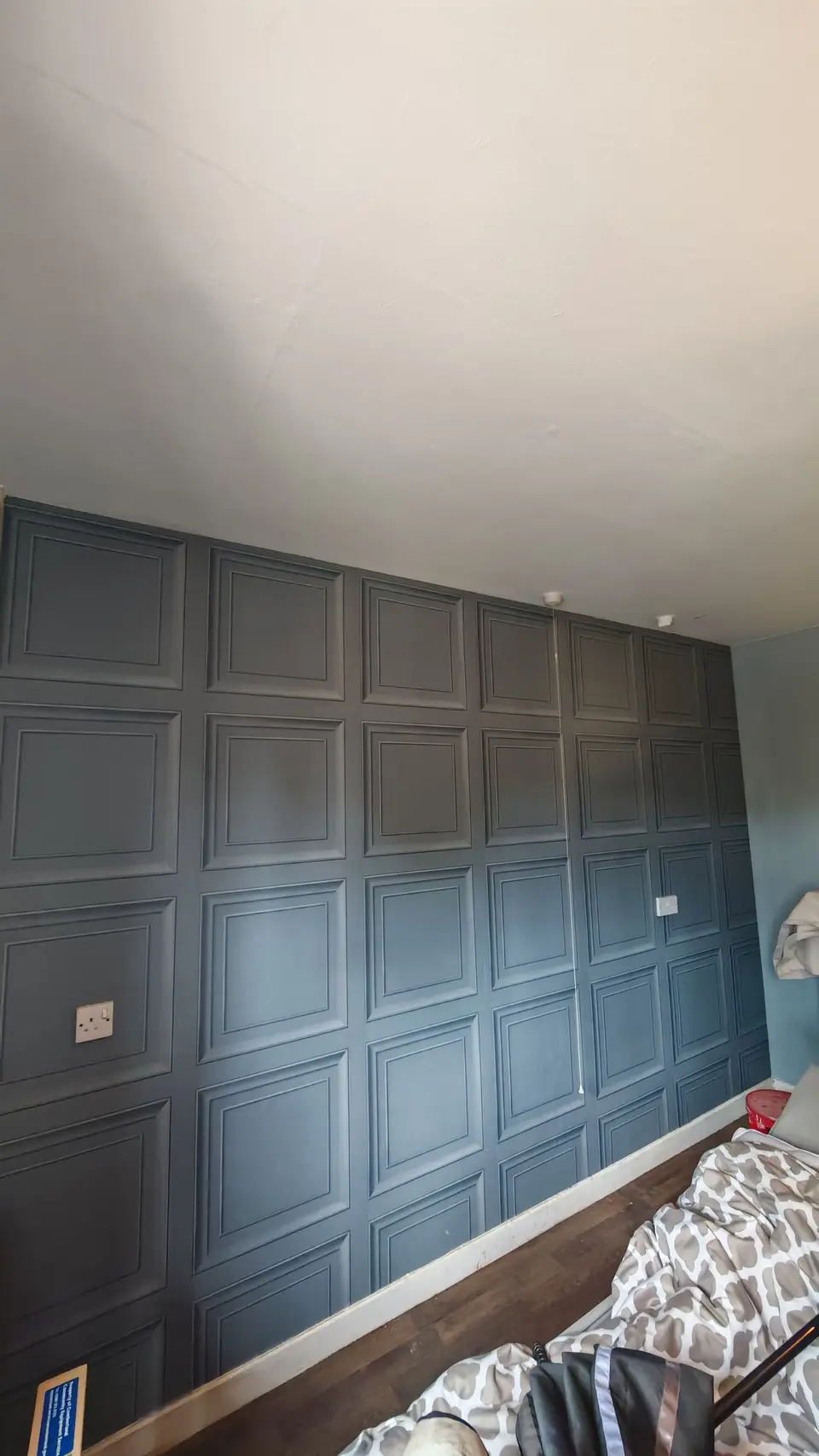 Bedroom feature wall with a panel effect, painted dark grey