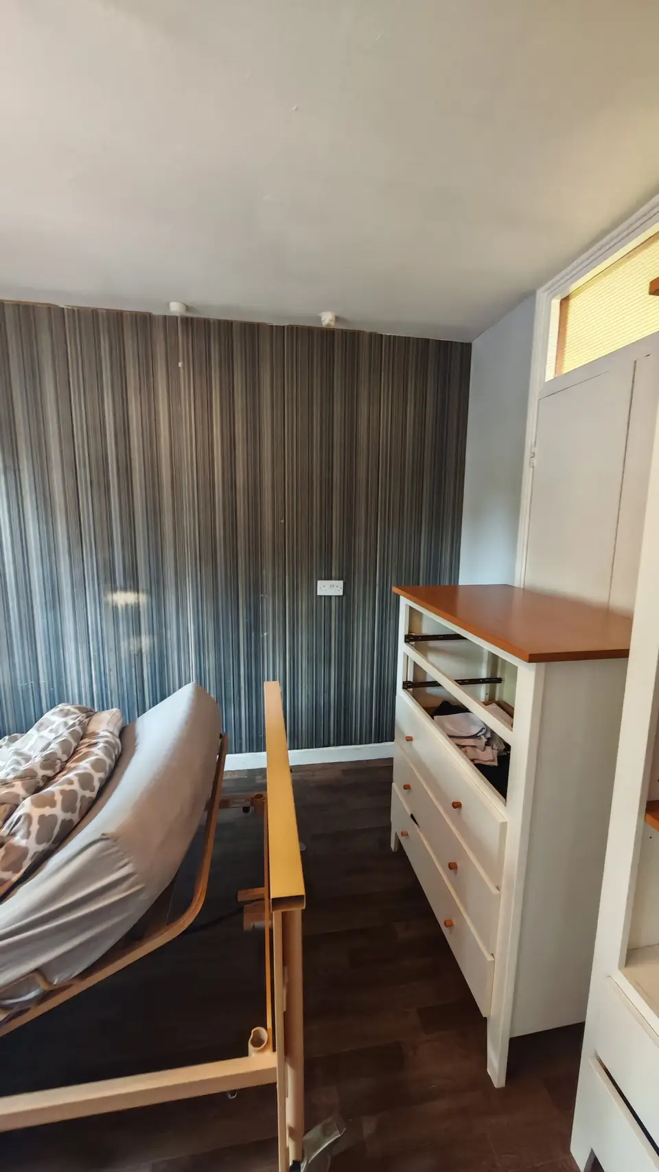 Before: bedroom wall in old striped wallpaper