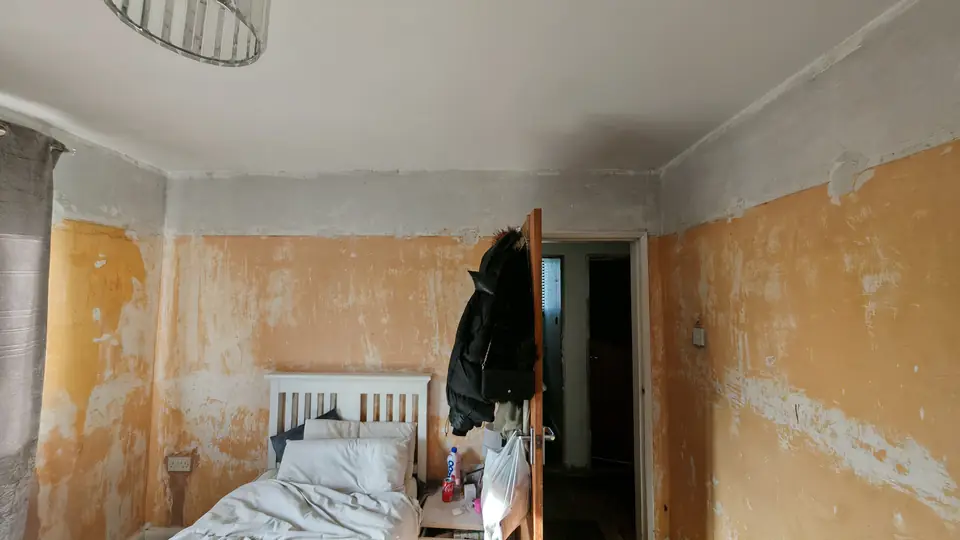 Before: stripped bedroom walls patched before skimming and painting
