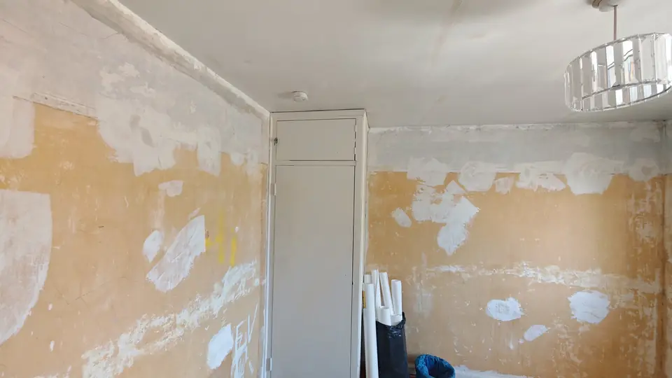Before: patched walls around the wardrobe
