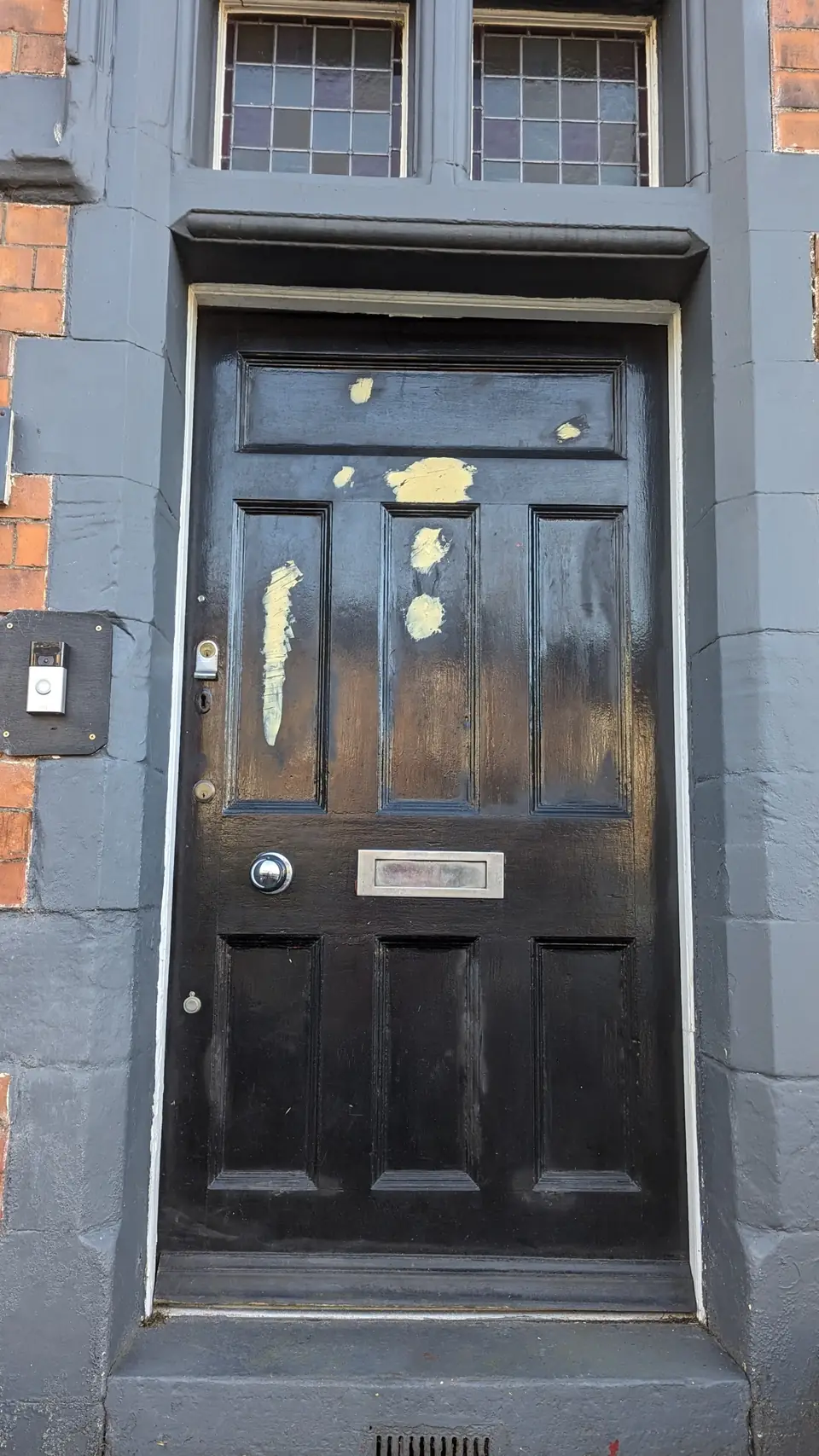 Before: period front door with old paint and filled patches