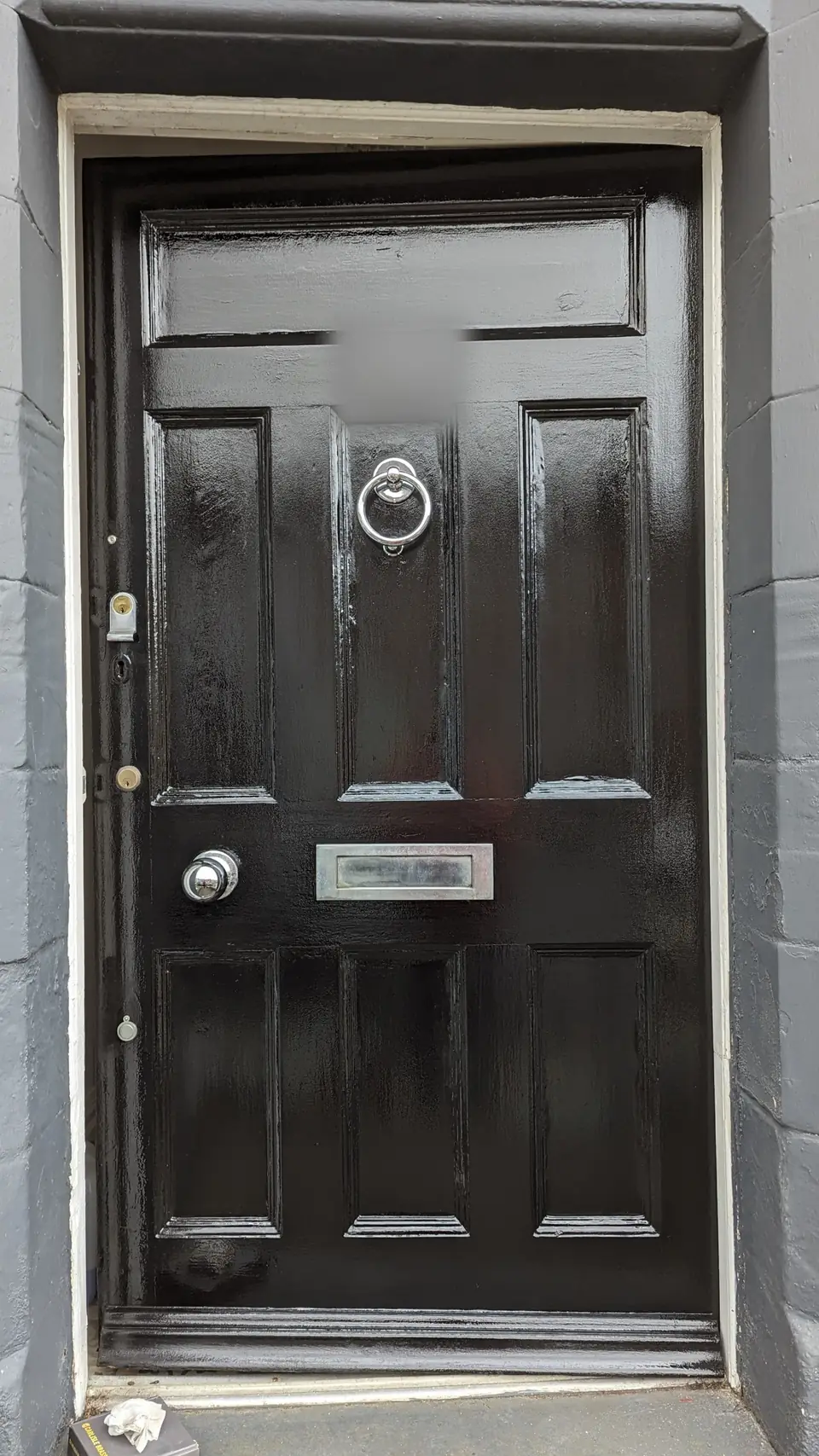 Period front door finished in deep black gloss