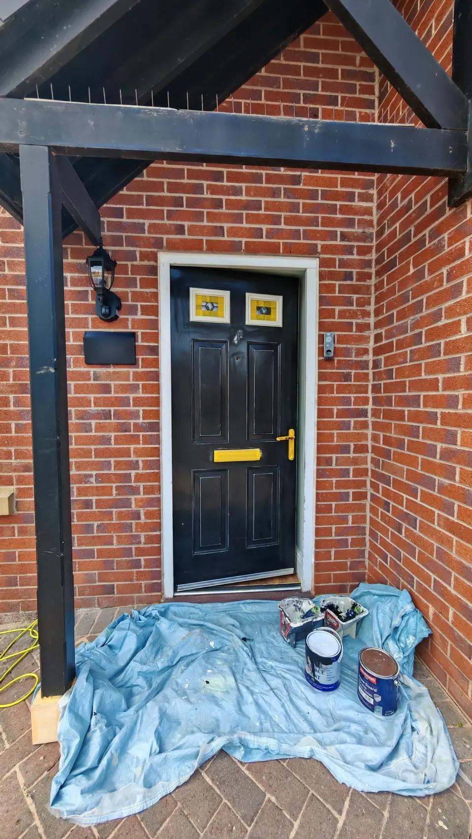 During: composite door and porch masked for black gloss