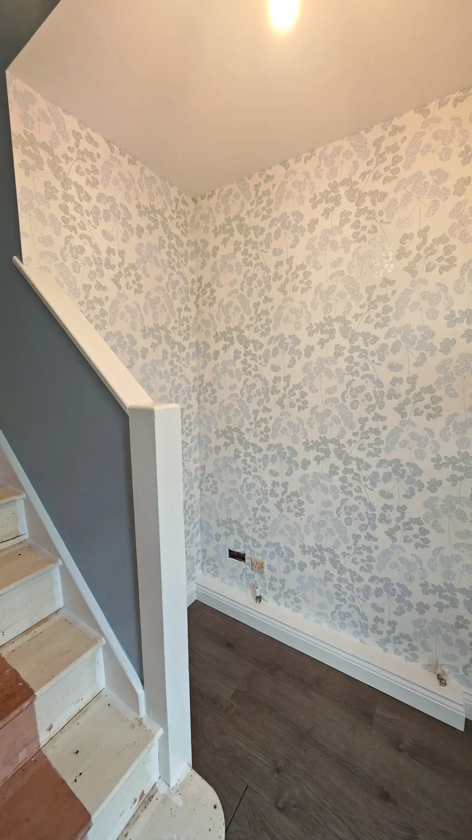 Hall feature wall in silver and grey-blue floral wallpaper, white woodwork