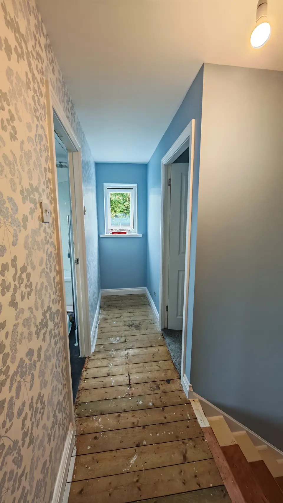 Landing walls in soft blue-grey with white ceiling and woodwork