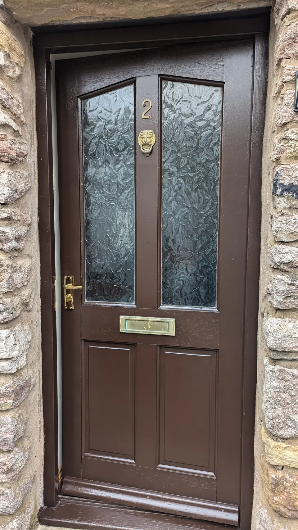 After: brown door with brass furniture