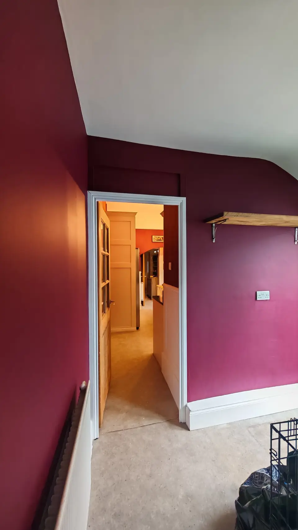 Burgundy painted room seen through a doorway