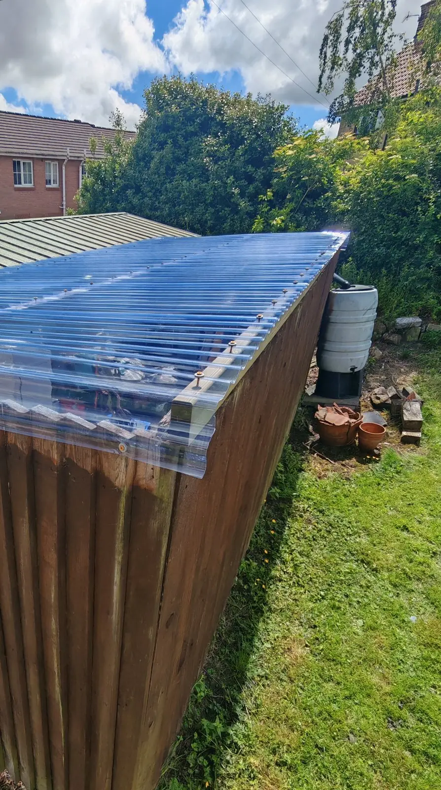 After: the same canopy with new clear polycarbonate roofing