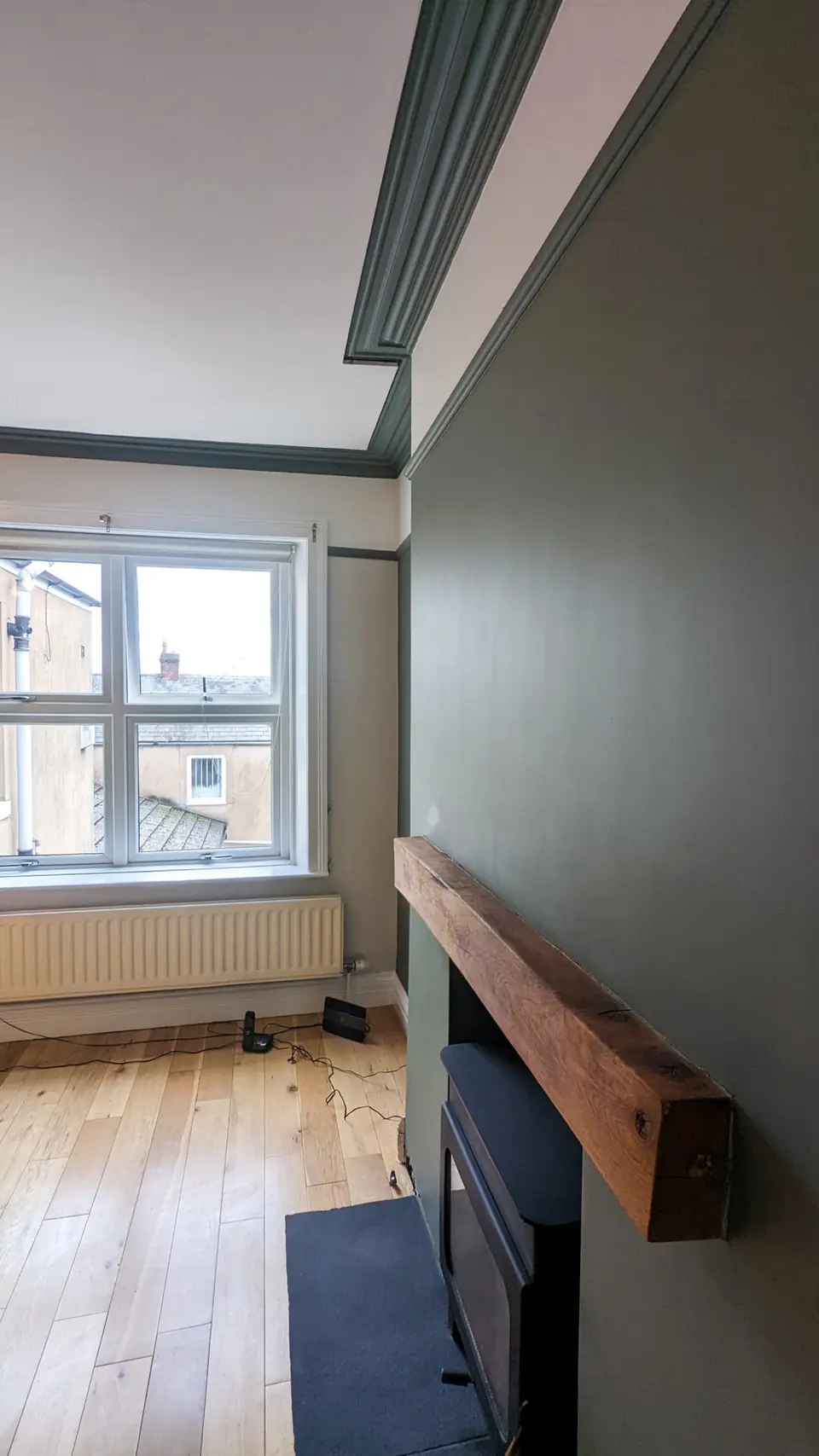 Charcoal painted chimney breast with timber mantel