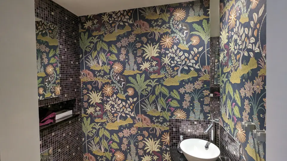 After: bold floral wallpaper around the basin