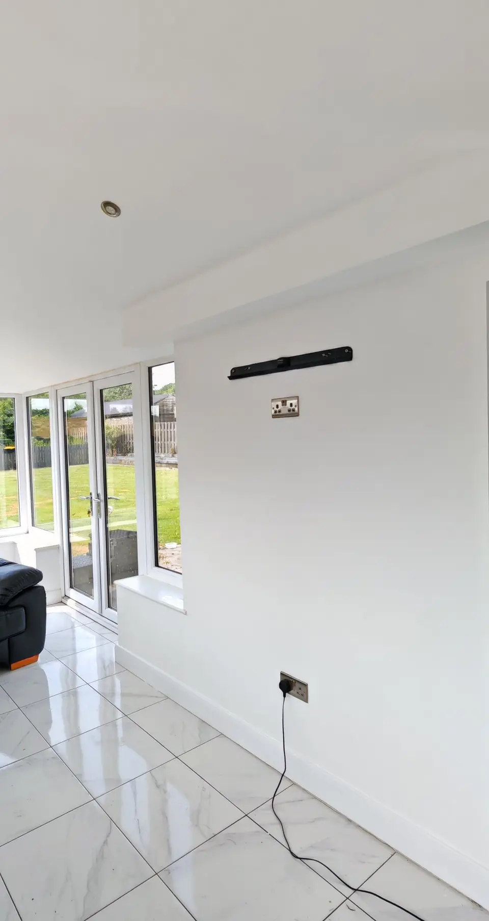 After: the same wall prepped and painted white