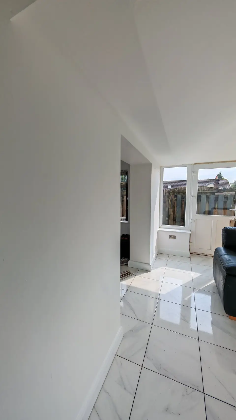 After: walkway into the conservatory, walls painted white
