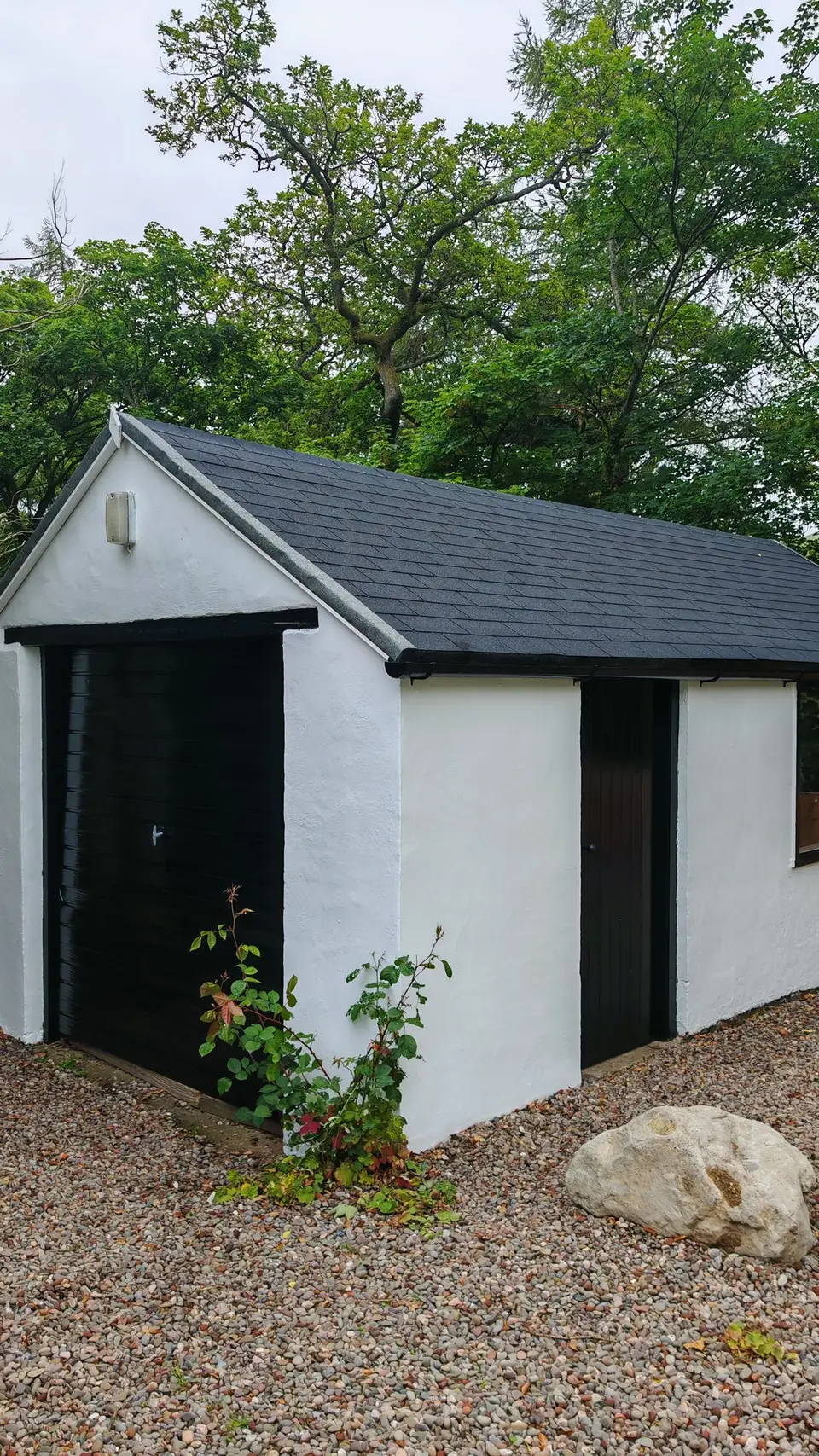 Garage render painted brilliant white, doors in black