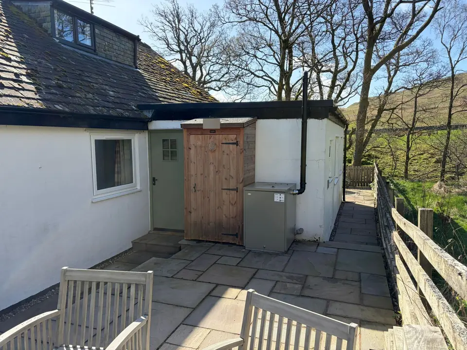 Before: patio wall by the sage green door