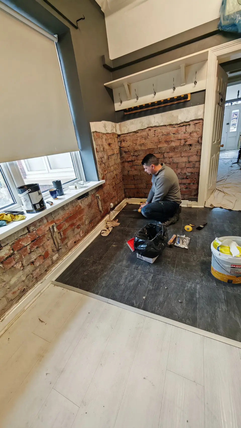 During: exposed brickwork being drilled and treated for damp
