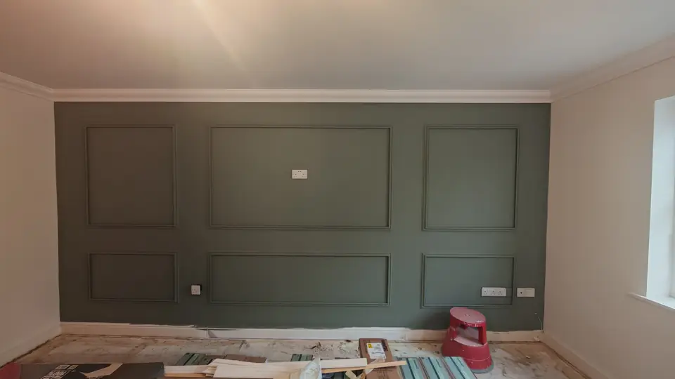 Feature wall with box panelling painted dark green