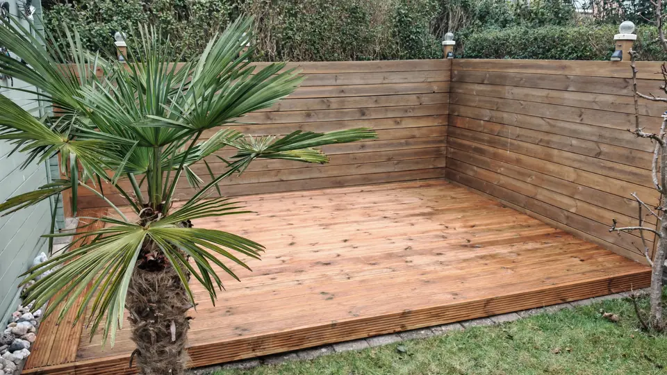 Stained decking and slatted fence