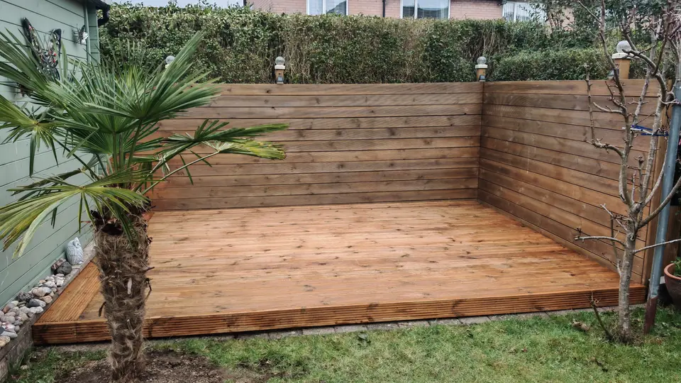 After: decking and fence stained warm brown