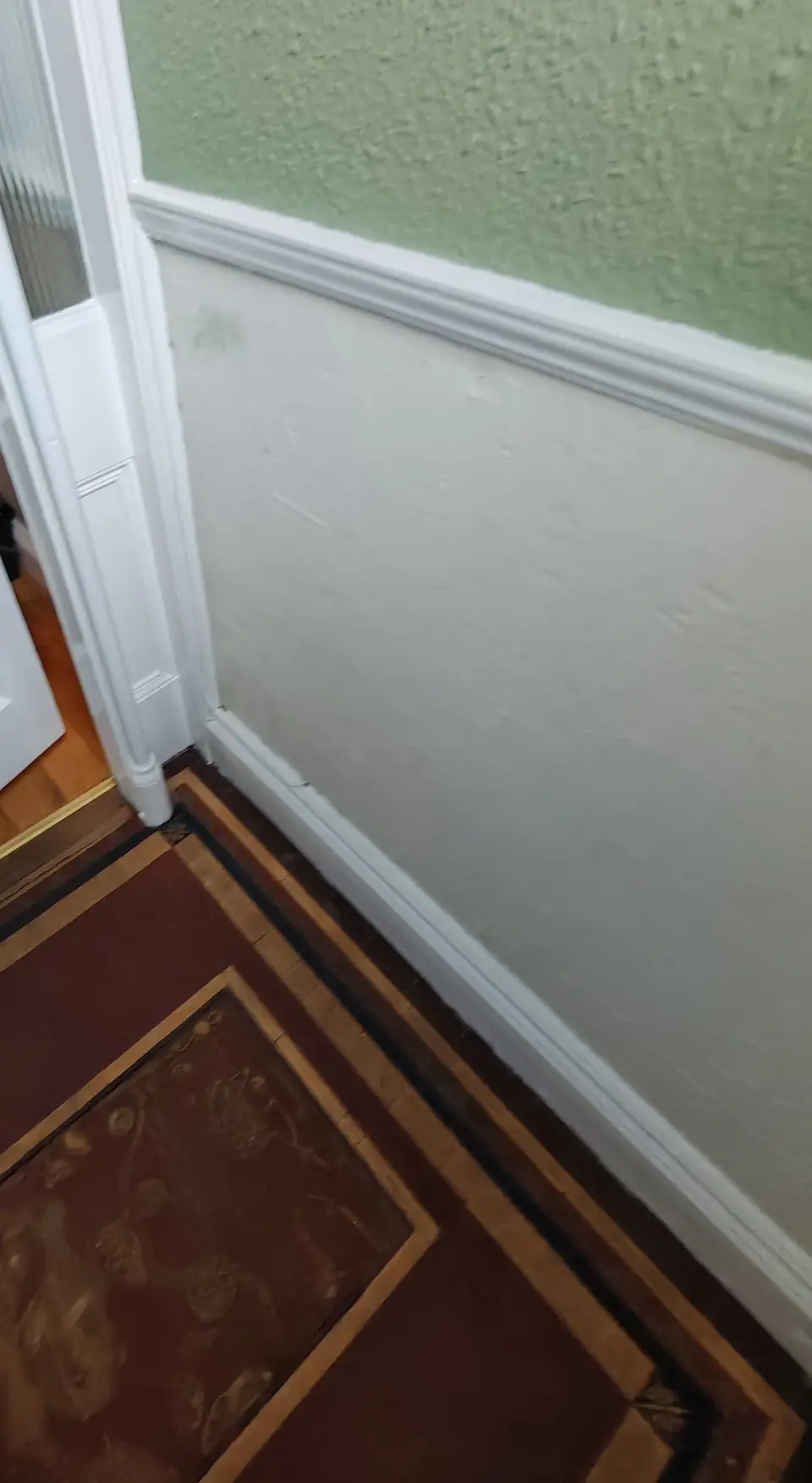 Detail: door frame, dado rail and skirting finished in white gloss