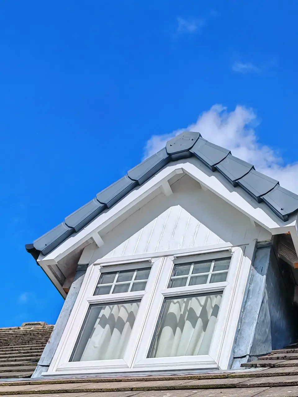 After: the same dormer prepped and glossed white