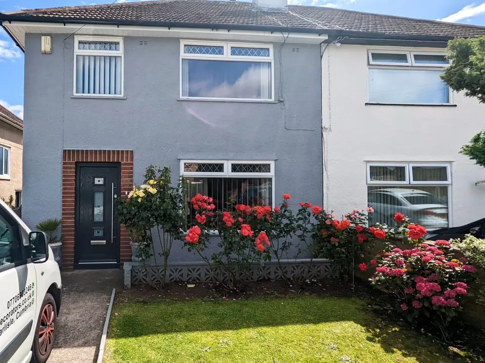 Semi-detached house exterior freshly painted in grey and white