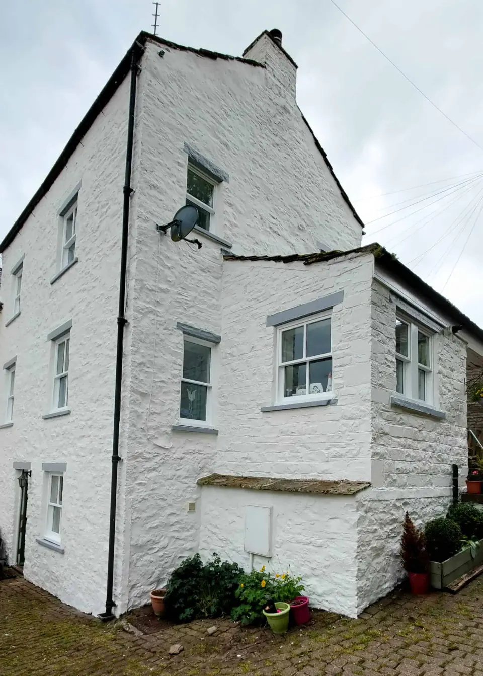 Traditional stone cottage painted brilliant white