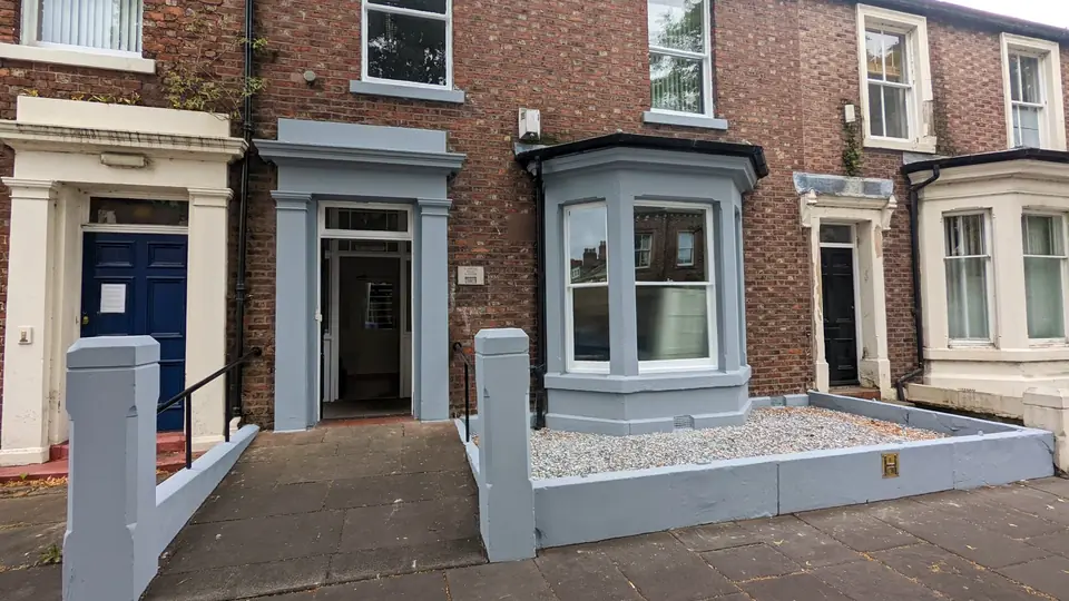 Terraced house frontage painted in grey and white