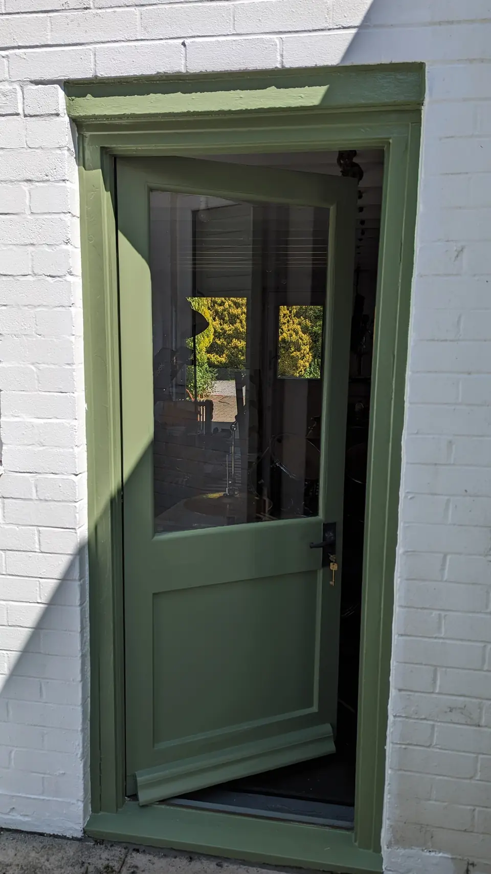 After: door and frame painted sage green