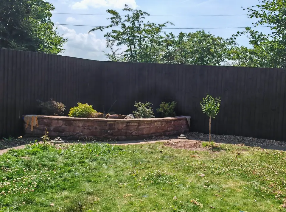 After: the same fence re-coloured dark brown