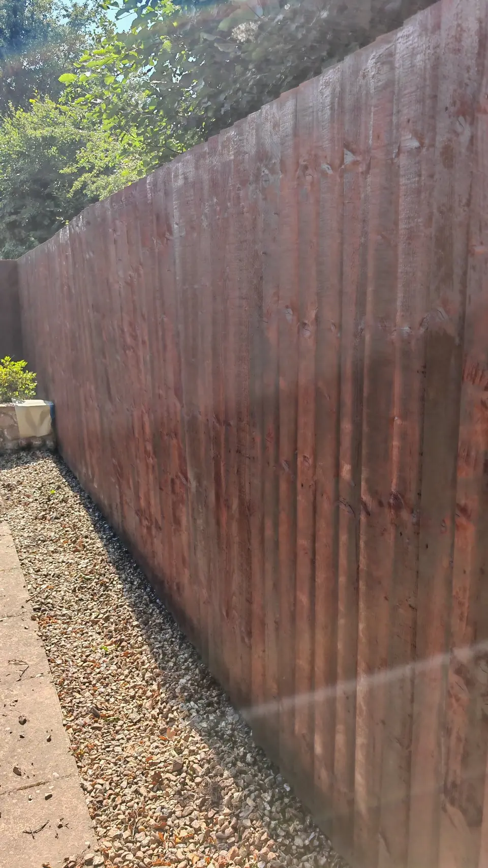 Fence panels re-coloured dark brown, close-up of the even finish