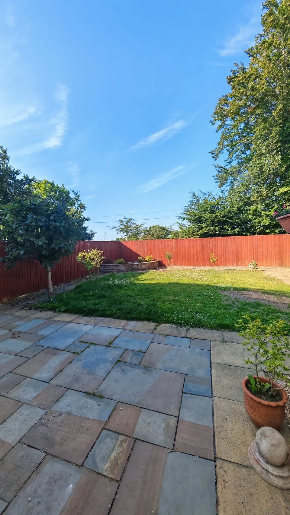 Before: the orange-red fence along the lawn