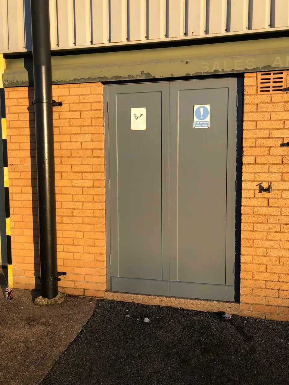 After: fire exit doors repainted in grey