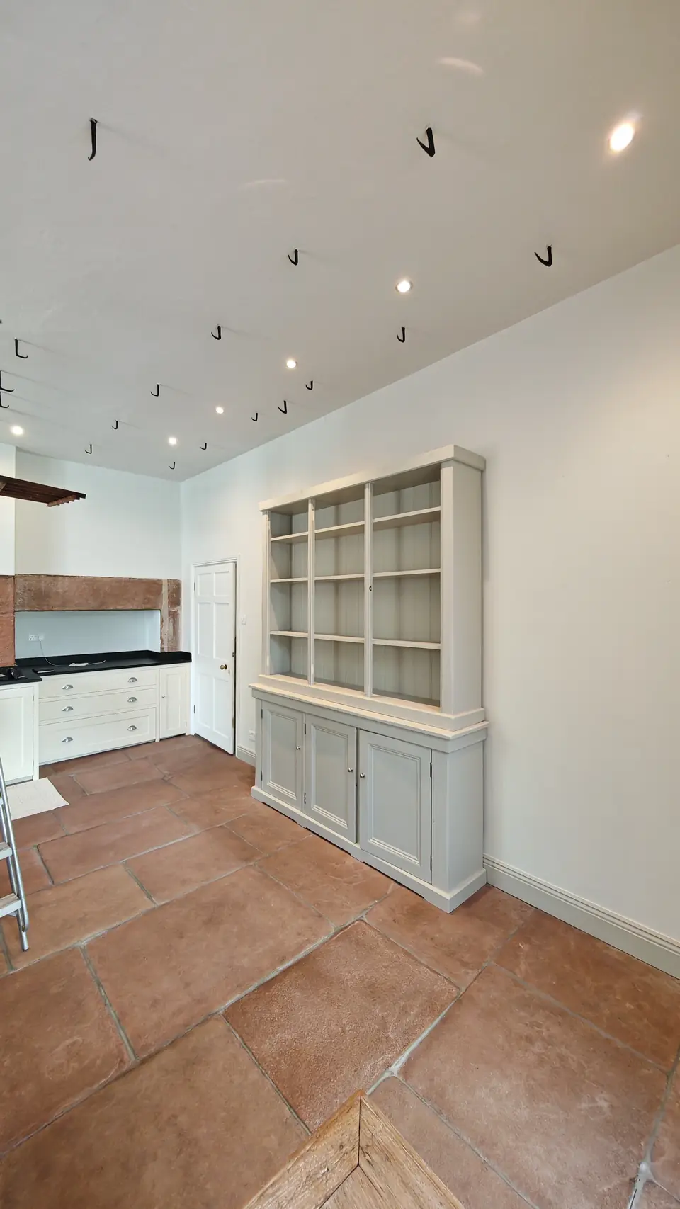 Period kitchen: walls and ceiling repainted white around the sage dresser