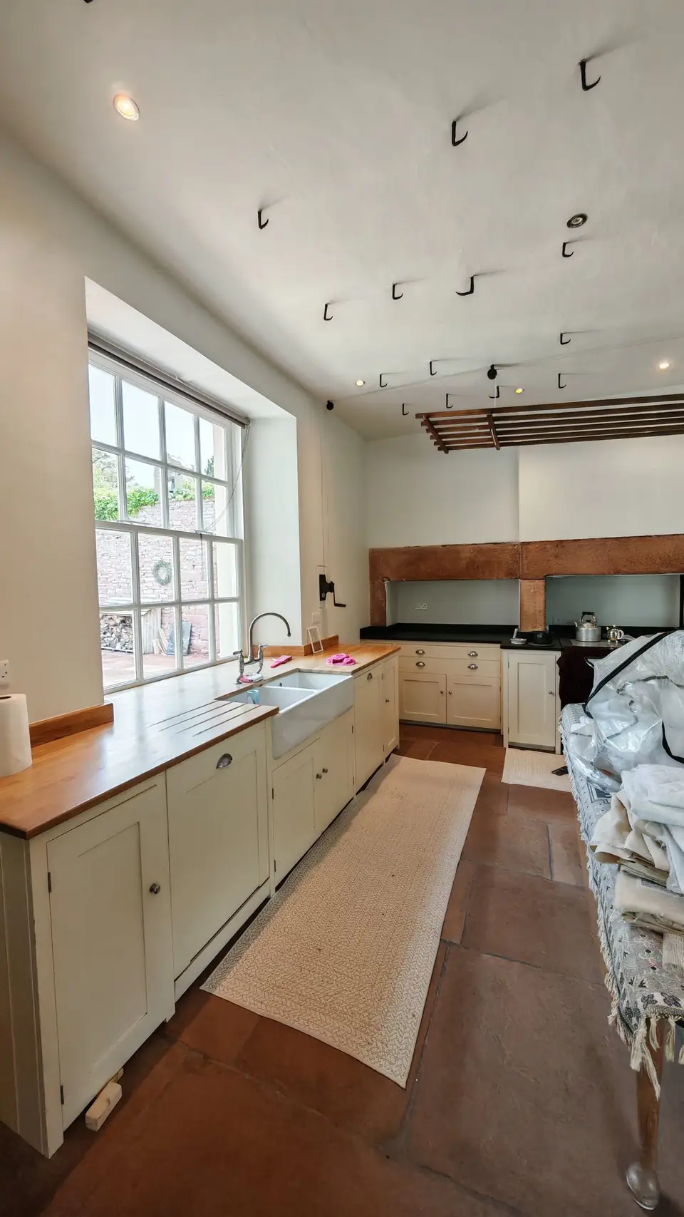 Period kitchen with flagstone floor, walls and ceiling freshly repainted