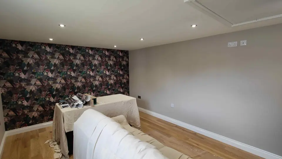 Dark floral feature wallpaper wall in a living room