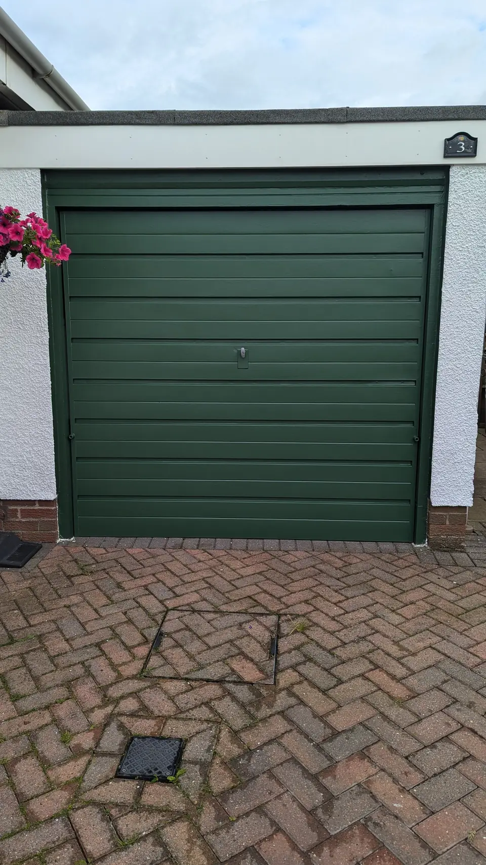 After: garage door sprayed dark green