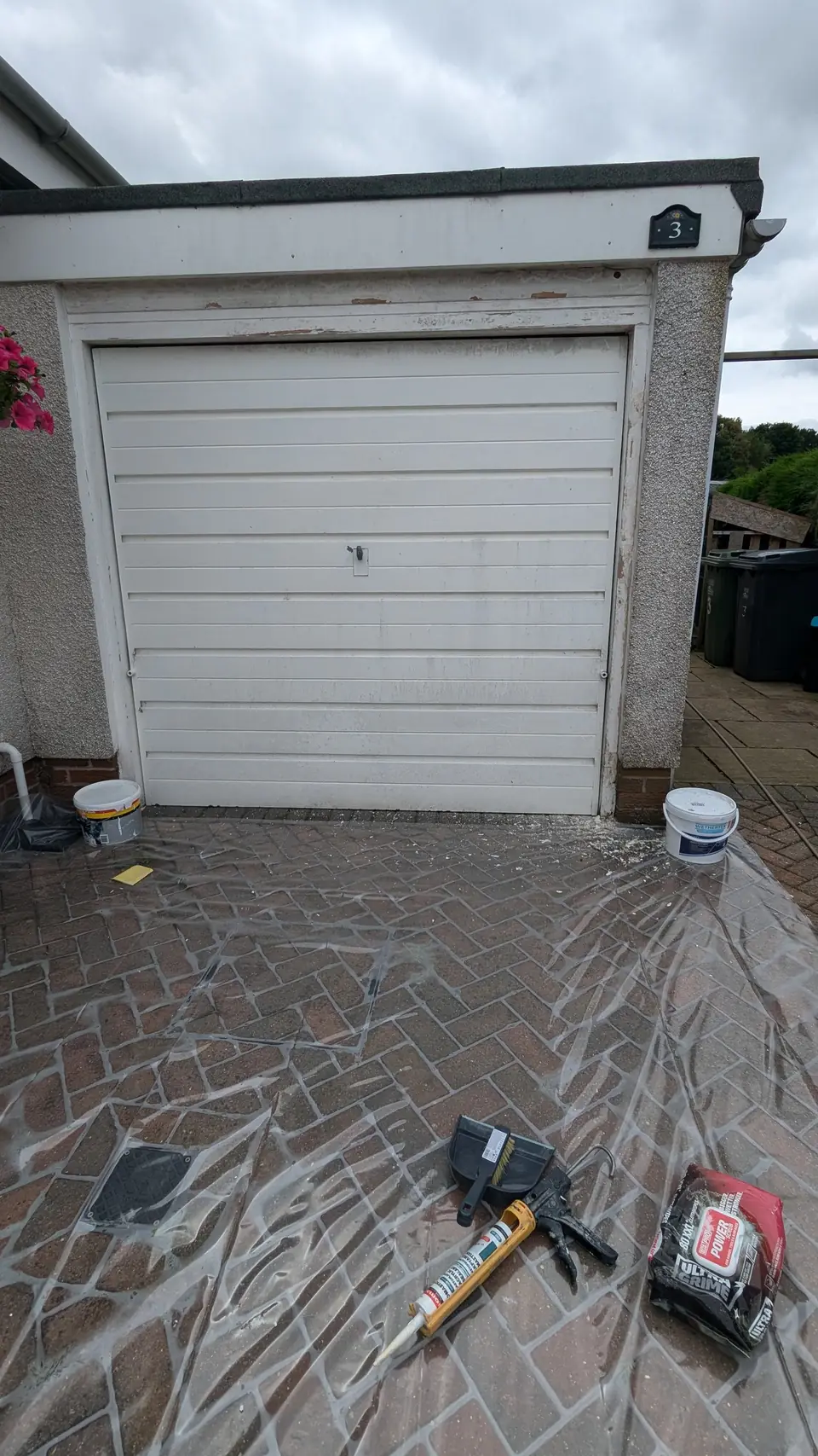 Before: white up-and-over garage door
