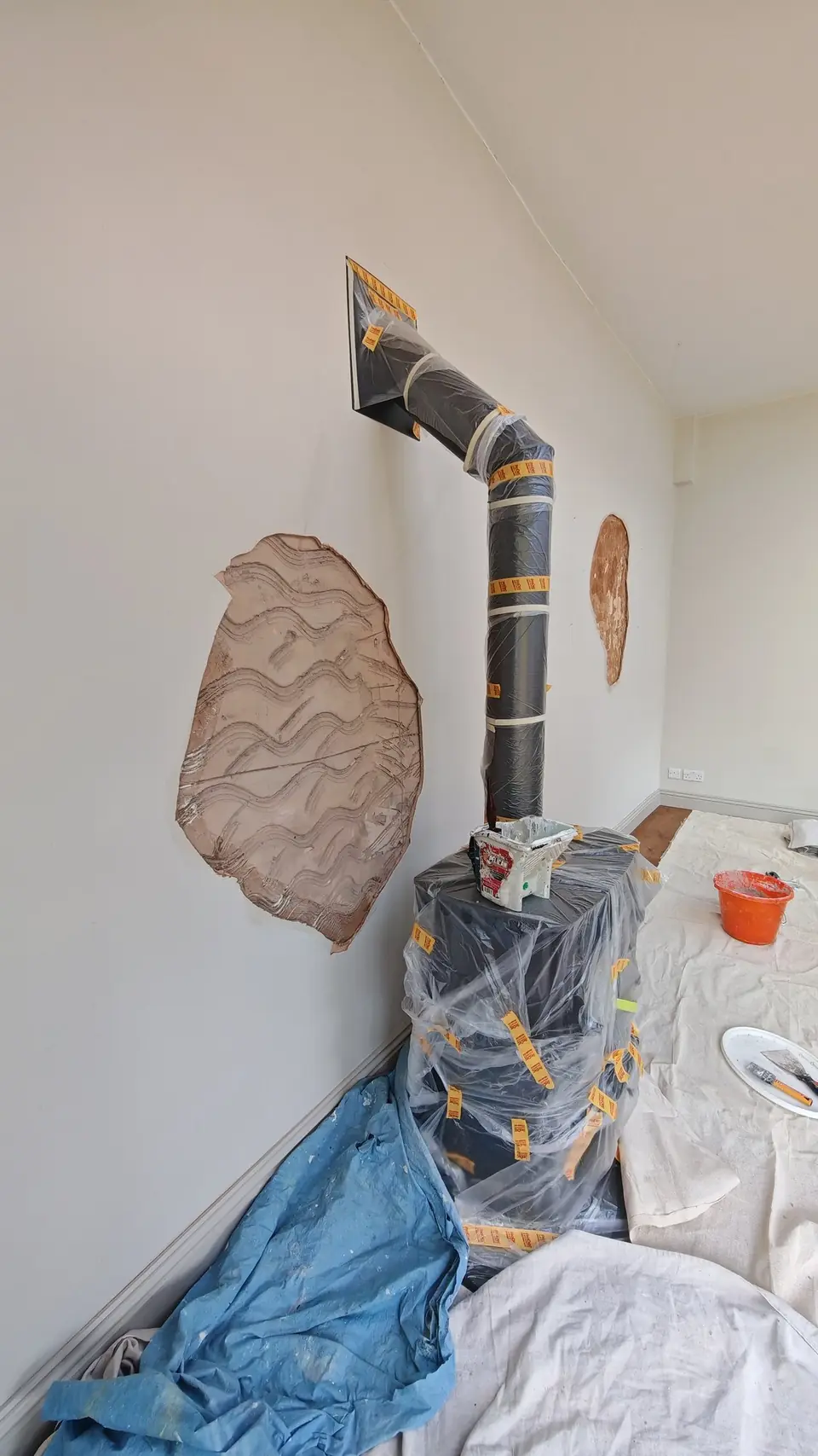 Prep: patches on the woodburner wall, stove masked