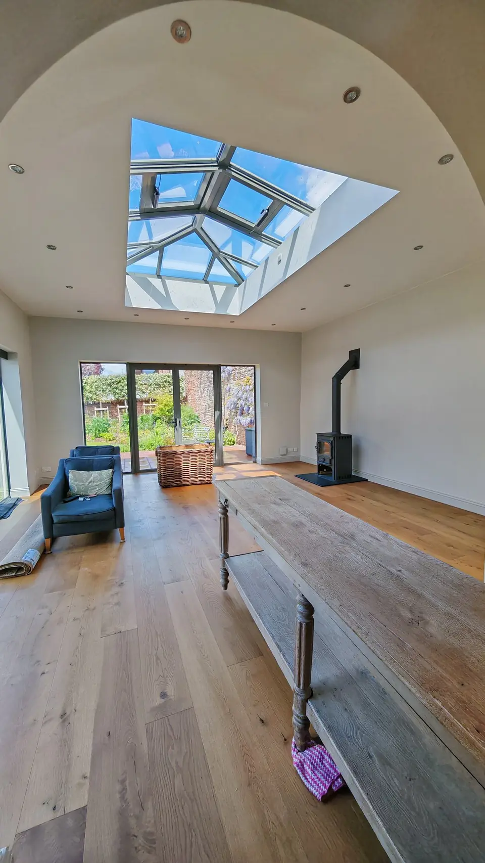 Garden room with roof lantern and woodburner, walls and ceiling repainted