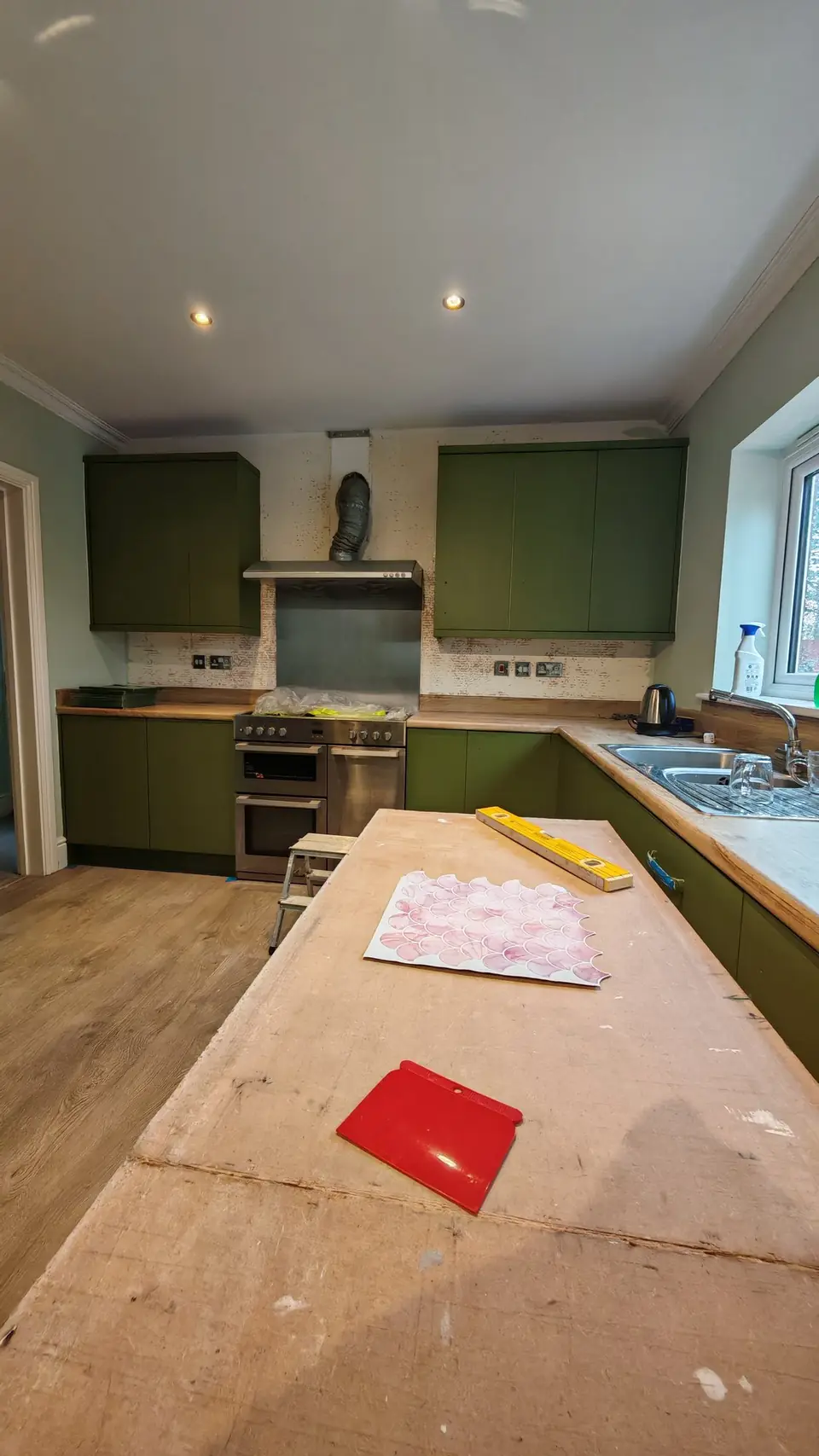 During: units painted olive green, old splashback still in place, tile sample on the side