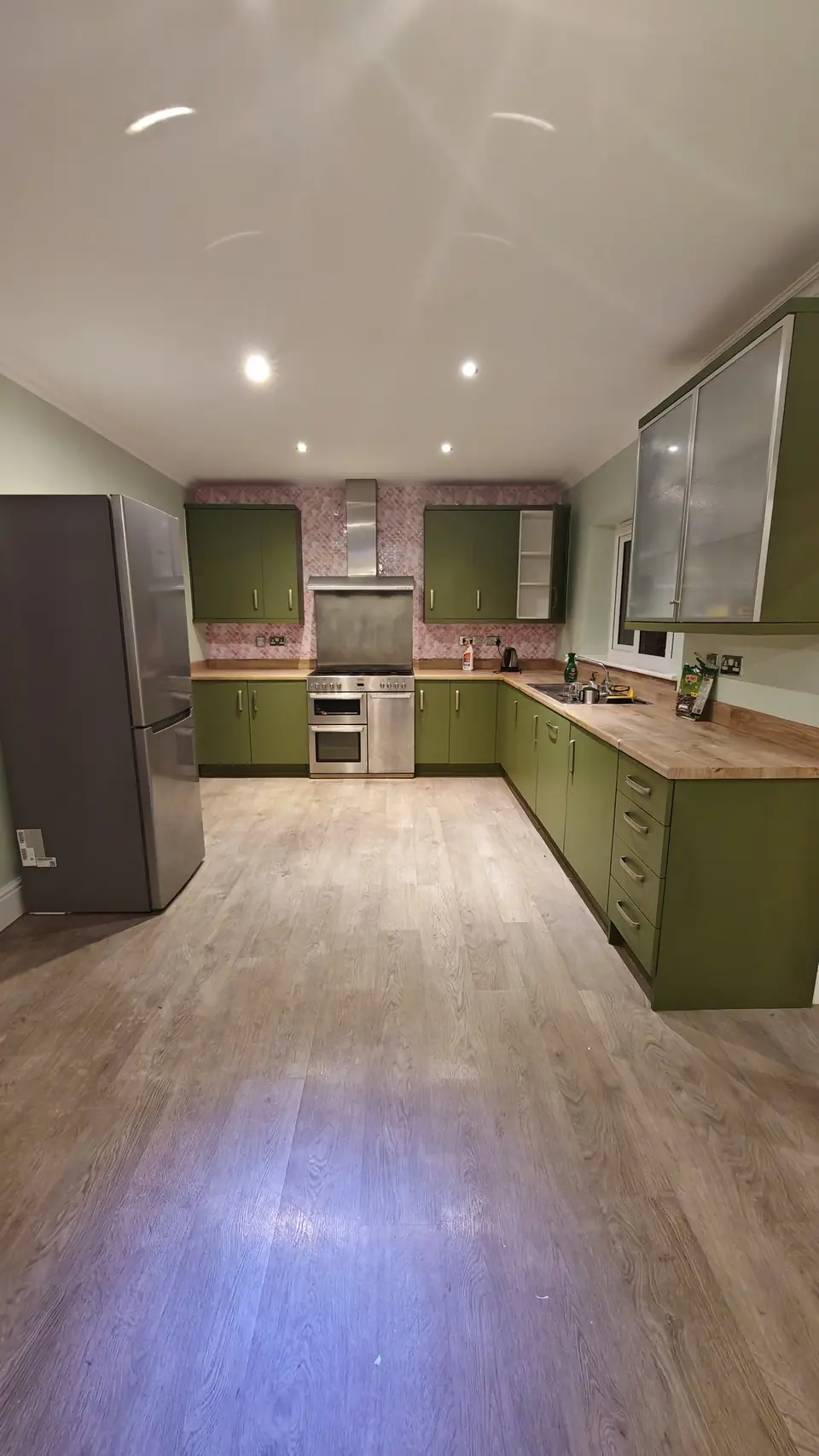 The whole olive green kitchen with light sage walls