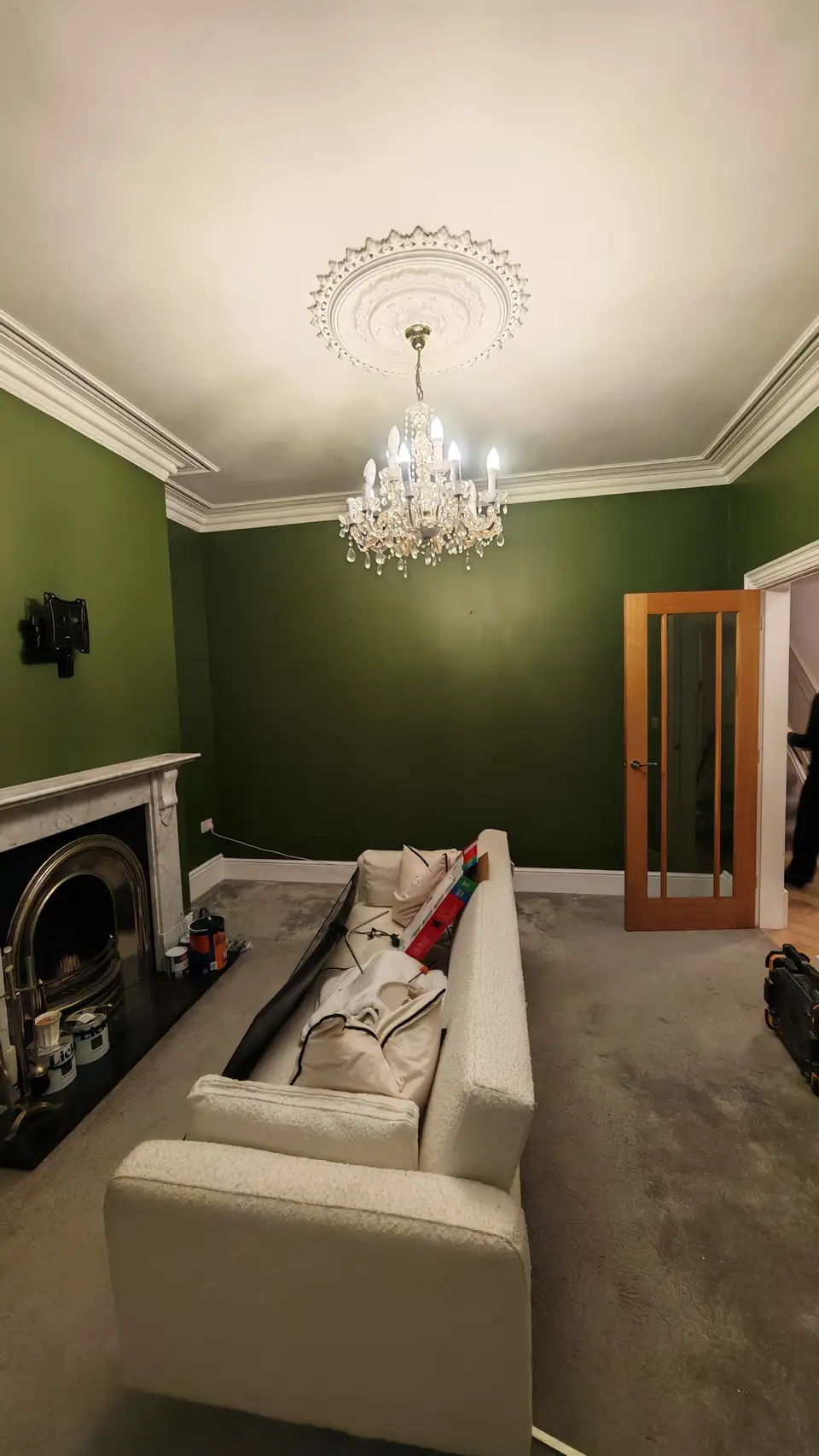 After: deep green walls, white fireplace and glazed door