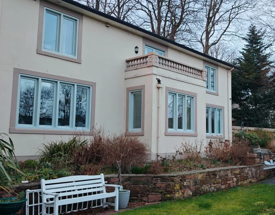 Sage green windows under the balustrade