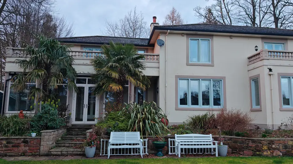 Garden elevation with every window and the French doors painted sage green