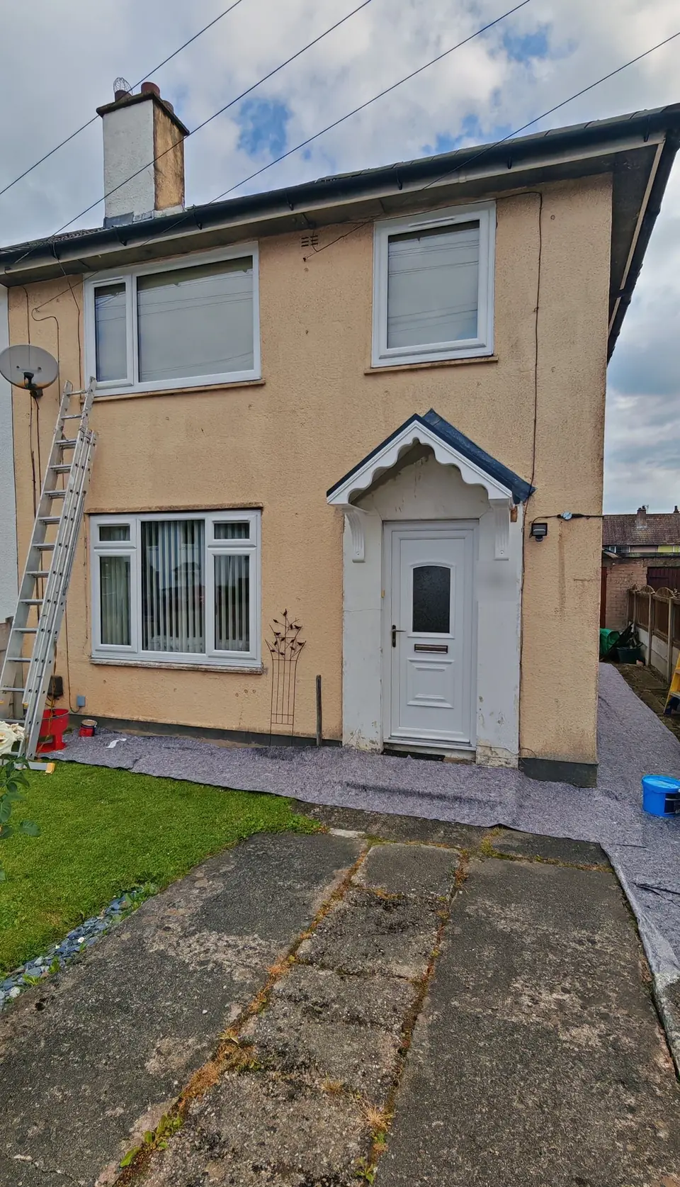 Before: semi-detached house in cream pebbledash, ladder up