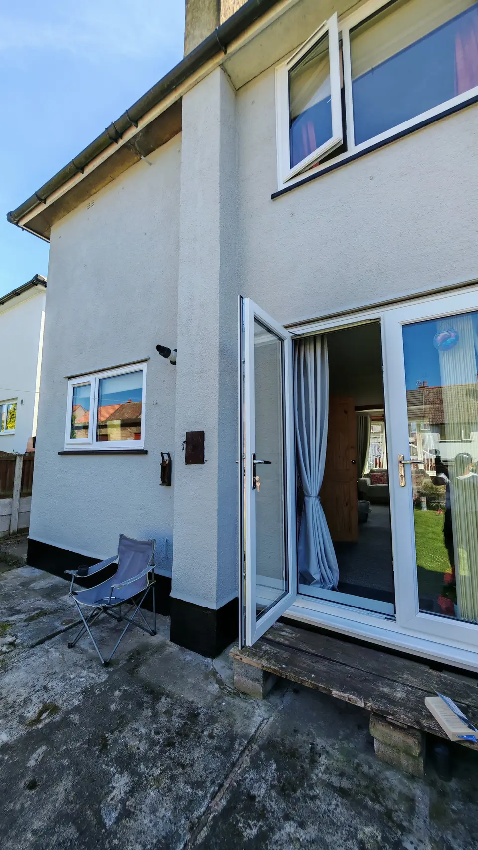 After: light grey render around the rear French doors