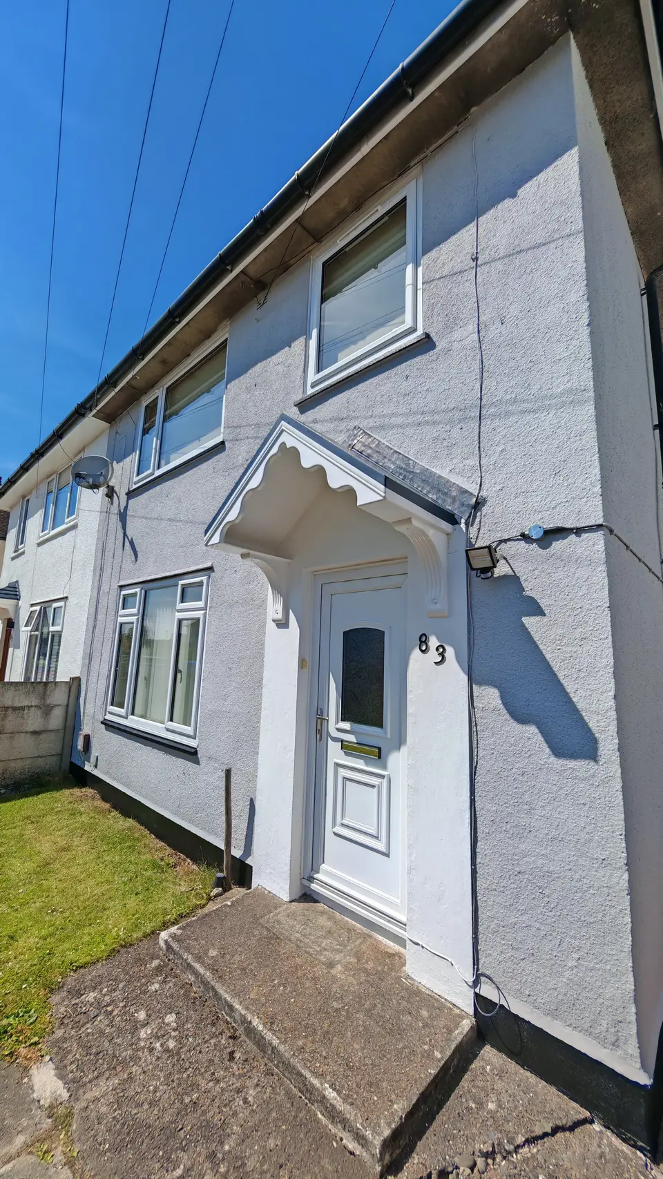 After: front porch and door surround in white against the light grey render
